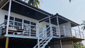 A two-story building with a balcony and a staircase. - Grand Sea Shades Goa (Canacona)