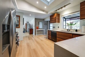 A modern kitchen with a built-in dishwasher, a large window with a view, and a skylight. - 1 Mi to Dtwn & Mill Avenue! Home w/ Outdoor Oasis (Tempe)