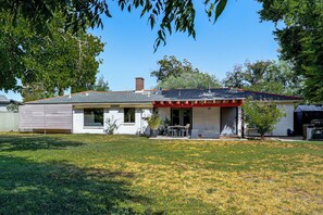 A single-story house with a covered patio, a chimney, and a lawn. - 1 Mi to Dtwn & Mill Avenue! Home w/ Outdoor Oasis (Tempe)