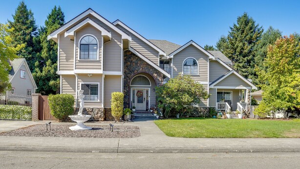 A two-story house with a stone facade, a front porch, and a small fountain. - 3 Mi to Sequoia Park Zoo: Spacious Home w/ Sunroom (Eureka)