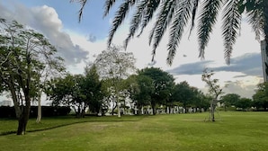 A grassy park with trees and a clear sky. - Vinhomes Skyline Apartment Saigon (Ho Chi Minh City)