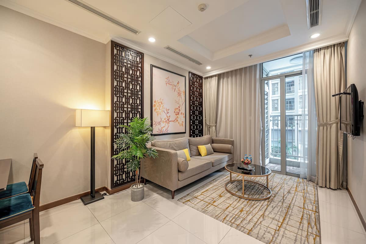 Deluxe Apartment, 1 Bedroom, Balcony, Courtyard View | Living area | Flat-screen TV, books