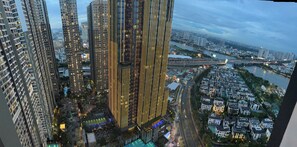 A high-rise building with a modern design, surrounded by other tall buildings and a river. - Vinhomes Skyline Apartment Saigon (Thanh pho Ho Chi Minh)