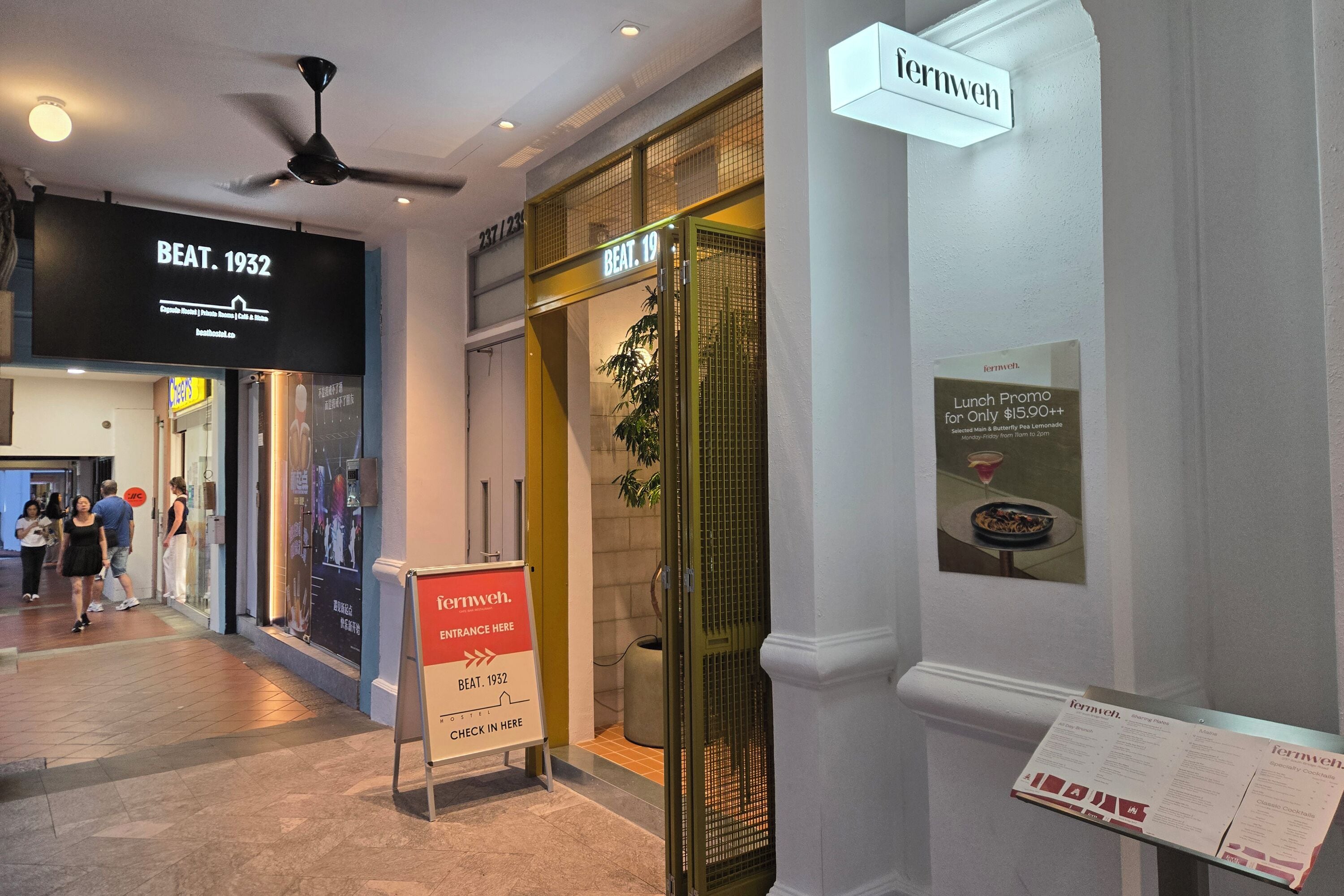 A hotel entrance with a sign for 'Beat. 1932' and a 'Lunch Promo' sign.