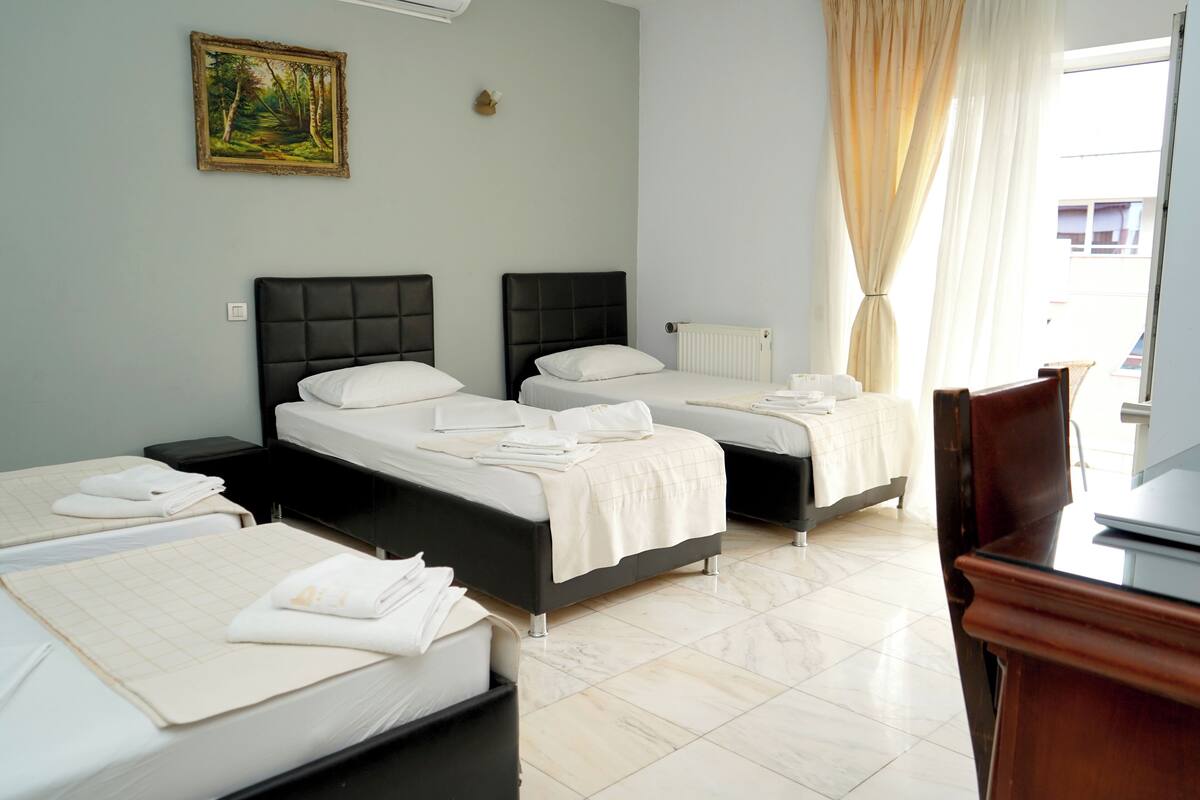 Family Quadruple Room, City View | In-room safe, desk, laptop workspace, soundproofing