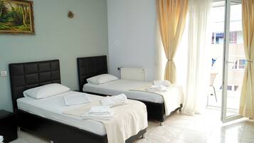 Family Quadruple Room, City View | In-room safe, desk, laptop workspace, soundproofing