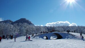 A snowy landscape with a bridge and people skiing. - Albergo Conte Max (Capracotta)
