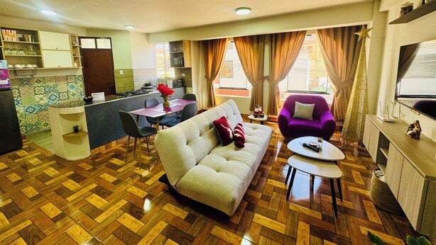 A living room with a sofa, a coffee table, and a dining area with a table and chairs. - Comfort in the heart of downtown Tacna (Tacna)