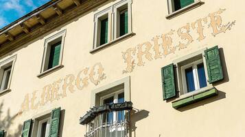 A building with the sign 'ALBERGO FRISTE' indicating a hotel.
