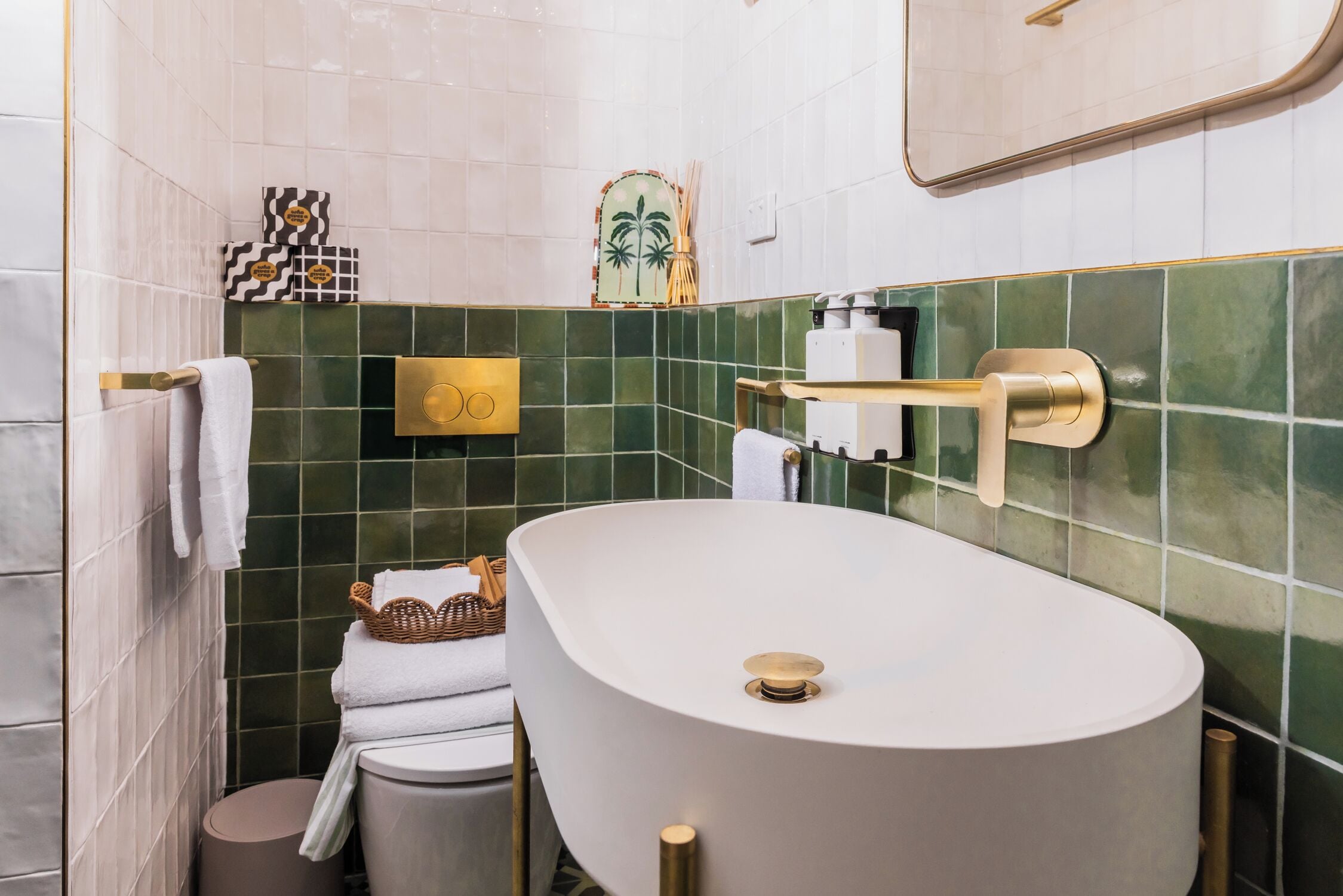 A bathroom with a freestanding bathtub, a toilet, and a sink.