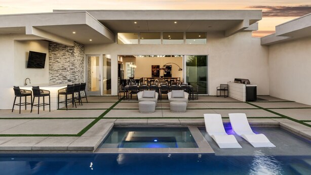 A modern outdoor living area with a pool, seating, and a dining area. - Oxygen @ Elemento49 - Pool & Spa - Sleeps 16 (Indio)