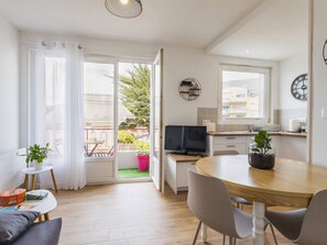 Un apartamento moderno con balcón, comedor y cocina.