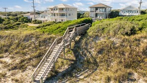 A wooden staircase leading to a beachfront property with multiple balconies and a view of the ocean. - Summer Days Cooler Nights #201 - 2nd Row Dog-Friendly House in Topsail Beach! (Topsail Beach)