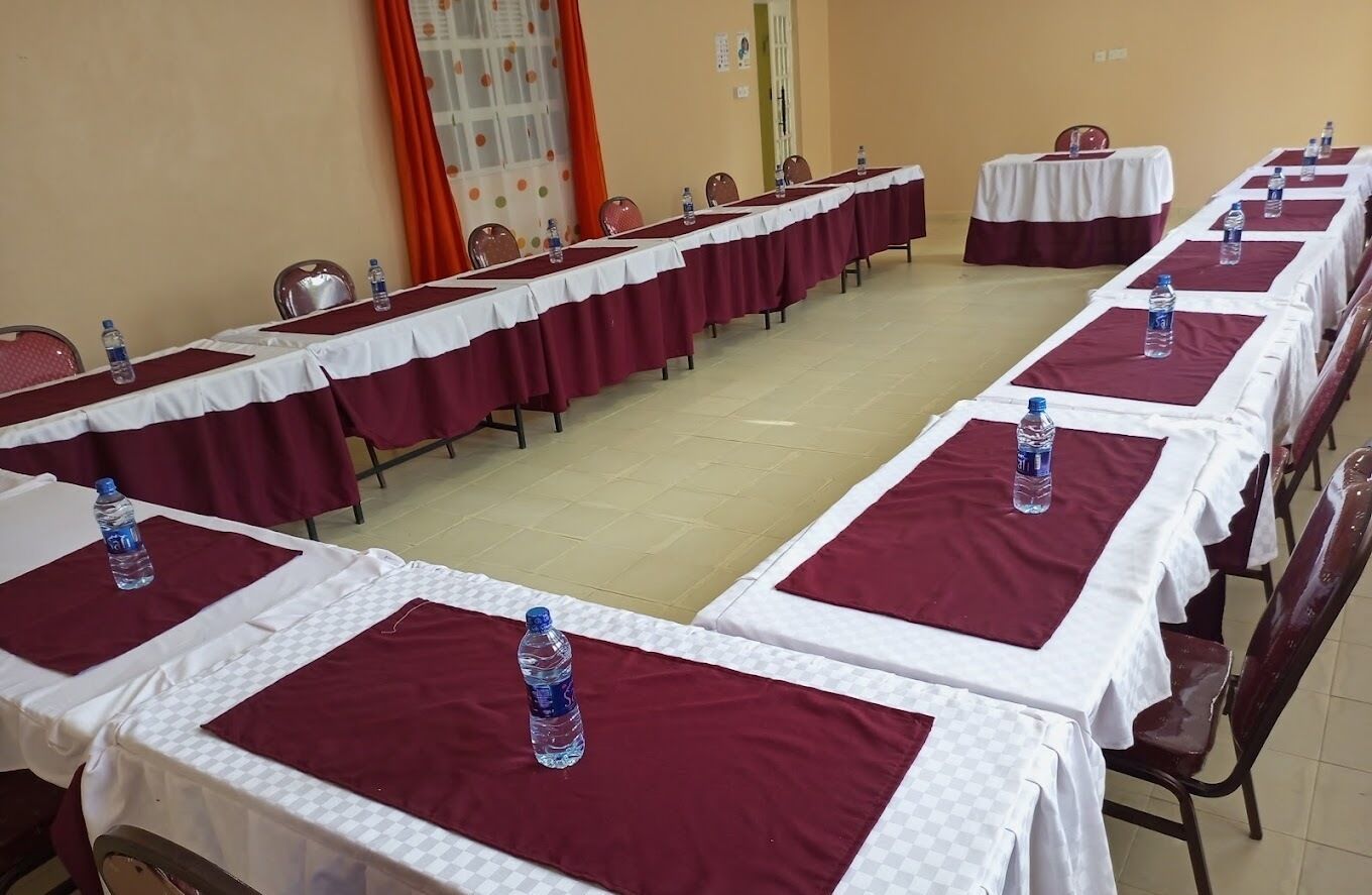 A conference room with long tables, each with a water bottle and a nameplate.