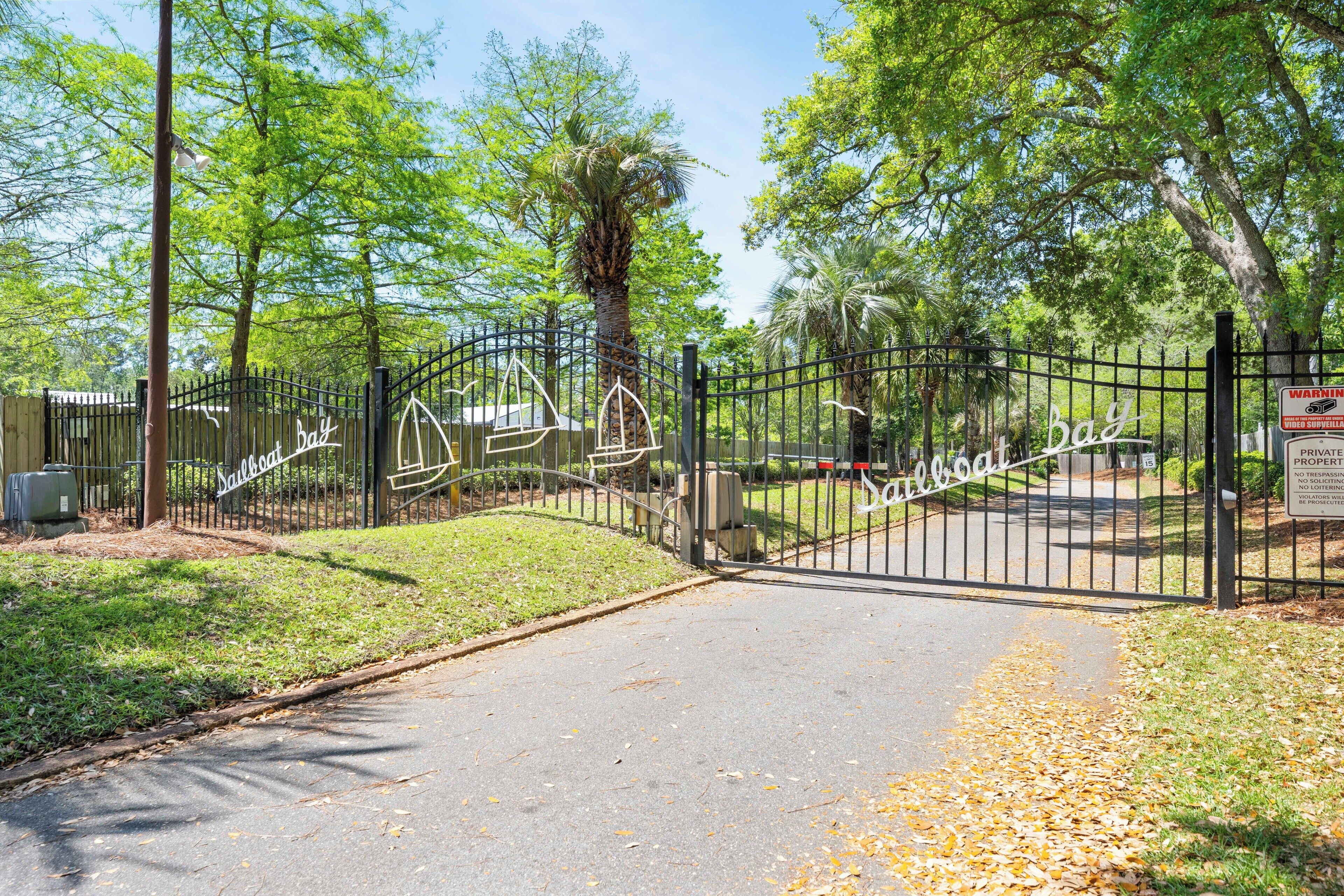 A gated entrance with a sign reading 'Bay' and a warning sign about video surveillance.