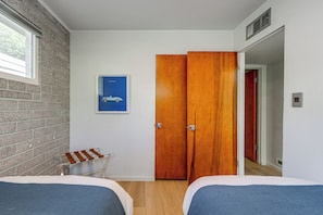 A room with two beds, a wooden wardrobe, a framed picture on the wall, and a window. - 1 Mi to Dtwn & Mill Avenue! Home w/ Outdoor Oasis (Tempe)