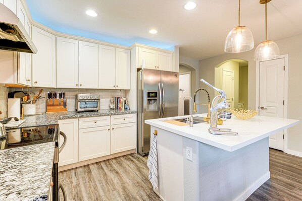 A modern kitchen with white cabinets, stainless steel appliances, and a central island. - Pool Access! Suburban Home 11 Mi to Dtwn Gilbert (Gilbert)
