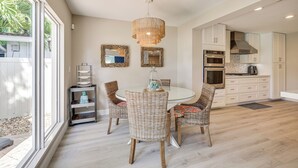 A modern kitchen with white cabinets, a built-in oven, and a stainless steel range hood. - Spacious Yard, Near Golf: Modern Home in Hollywood (Hollywood)