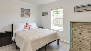 A bedroom with a bed, a dresser, and a window. - Fish, Swim & Explore: Panama City Gem w/ Boat Slip (Panama City)