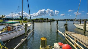 A marina with docked boats, wooden piers, and calm water. - Fish, Swim & Explore: Panama City Gem w/ Boat Slip (Panama City)