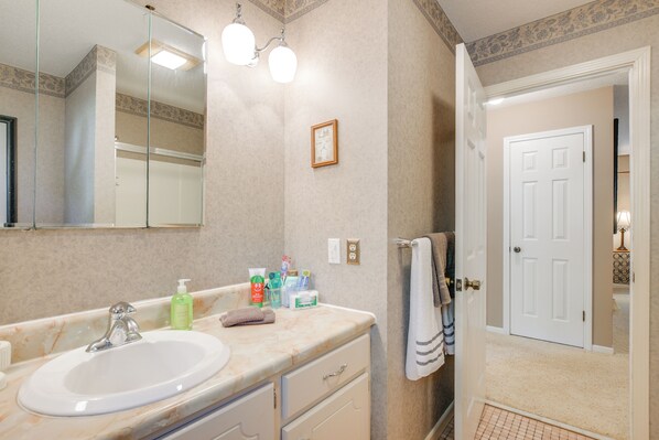 A bathroom with a sink, mirror, and towel rack. - Lake Hartwell Retreat w/ Lake Access & Firepit (Townville)