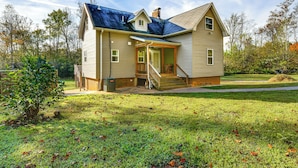 A two-story house with a front porch, a covered entryway, and a small attached garage.