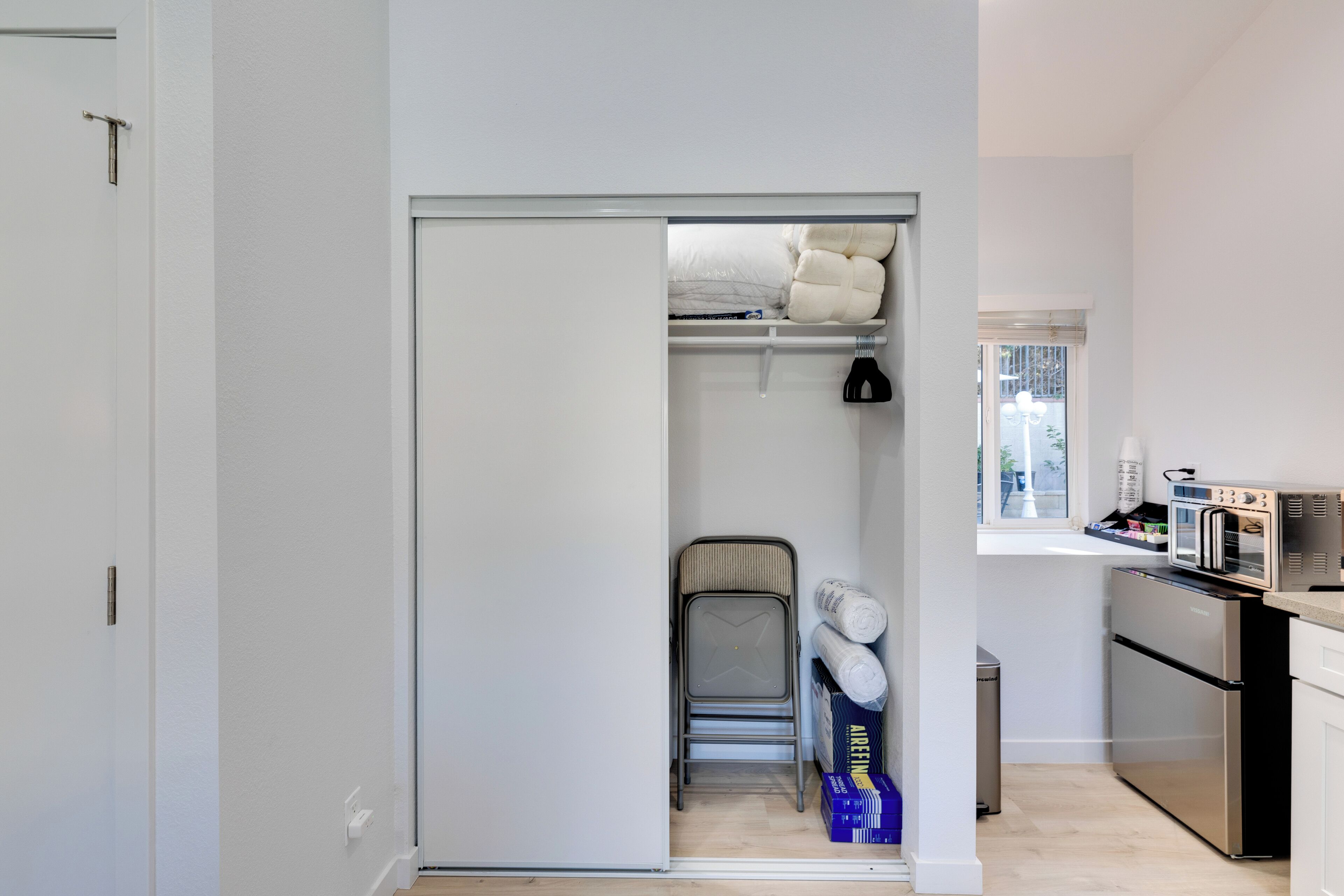 A compact kitchen with a built-in oven and a small dining area.