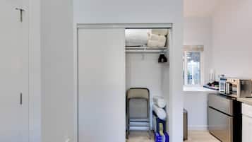 A compact kitchen with a built-in oven and a small dining area.
