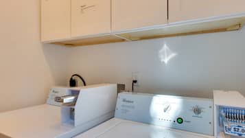 A Whirlpool commercial washer with a control panel, a price tag, and a Whirlpool logo.