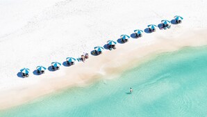 An aerial view of a beach with rows of beach umbrellas and lounge chairs. - Gulf Front - Unsurpassable Views - Pool - Workout Room - Private Beach Access (Santa Rosa Beach)