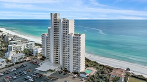 A high-rise hotel with multiple floors, a parking lot, and a beach view. - Gulf Front - Unsurpassable Views - Pool - Workout Room - Private Beach Access (Santa Rosa Beach)