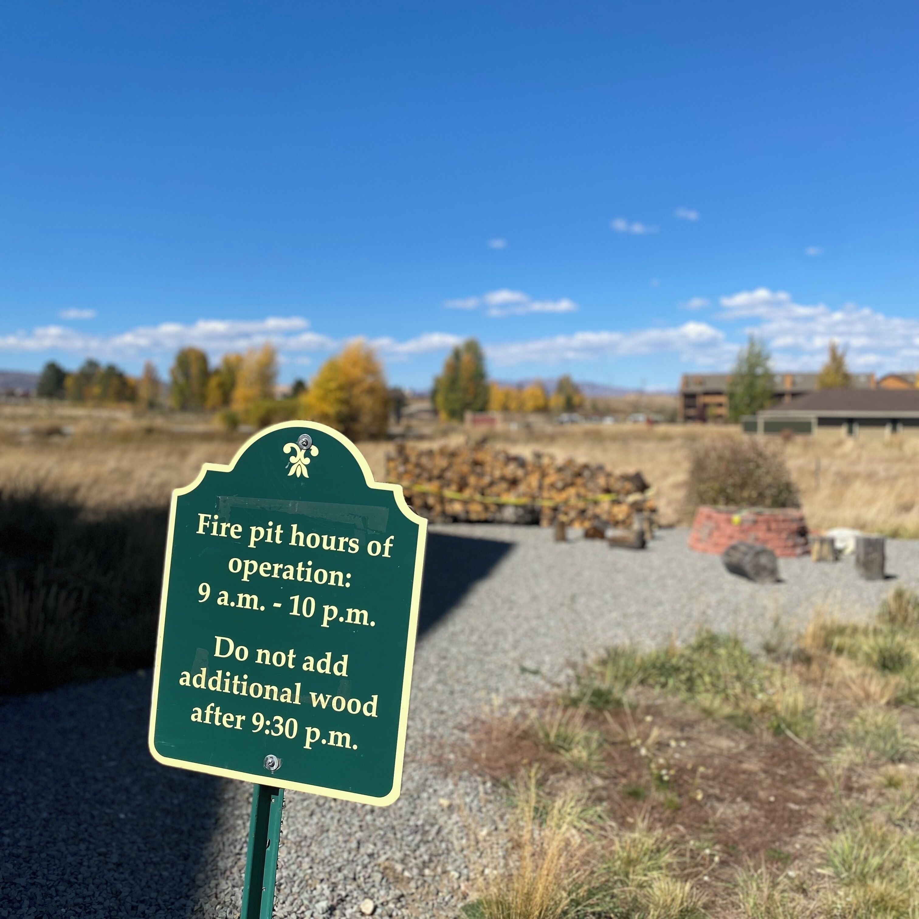A sign indicating fire pit operation hours and restrictions.