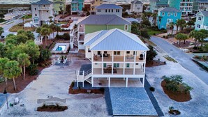 A coastal residential area with multiple beachfront houses, a swimming pool, and a beach access walkway. - Lulu's Beach House- Volleyball Court, North Cape (Port St Joe)