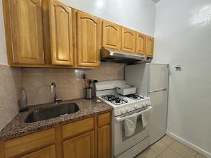 Fridge, oven, cookware/dishes/utensils, dining tables - Large 1-Bed Steps from Penn Station (New York)