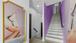 A staircase with a purple wall and a framed artwork on the left. - NEW! Sleeps 20+ 2 SideBySide East Nashville Homes! (Nashville)
