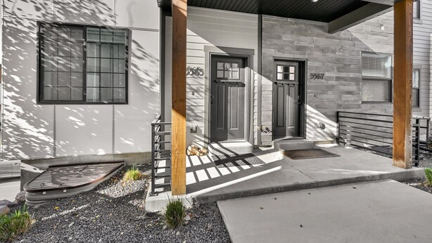 A modern house with a grey exterior, a wooden porch, and a number '5567' on the door. - Eden Townhouse: Hot Tub & Golf Retreat w/Mountain Views (Eden)
