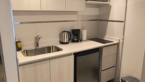 A modern kitchen with a built-in microwave, stainless steel sink, and a dishwasher. - Vianzo BA (Buenos Aires)
