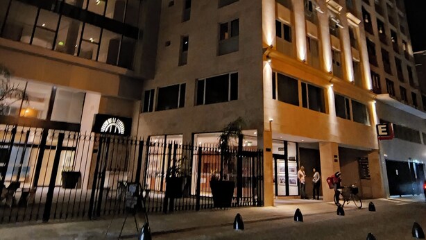 A multi-story hotel with a modern facade, large windows, and a well-lit entrance area. - Vianzo BA (Buenos Aires)