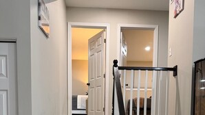 A staircase with wooden steps and black balusters leading to a landing. - 


Inviting Bethesda Stay – Clean, Cozy & Convenient (Bethesda)