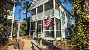 A two-story house with a covered porch and an American flag. - NEW The Funky Oyster A4 w/Pool access Port  St Joe (Port St. Joe)