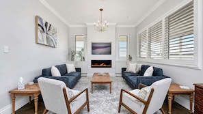 A living room with two sofas, a coffee table, and a fireplace.