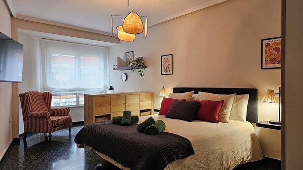 A modern bedroom with a bed, a chair, a desk, and a window. - Apartment AH2 by Gestión House. VUT-6514-AS (Noreña)
