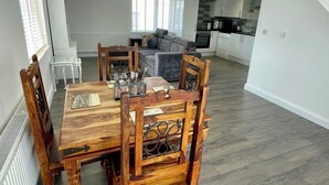 A modern kitchen with white cabinets, a black countertop, and a built-in oven. - Studio Apartment in Londonderry (Londonderry)