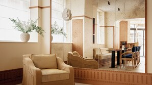 A spacious living area with a sofa, chairs, a dining table, and a large window with a view. - HIGHSTAY Maisons - Vintimille (Paris)