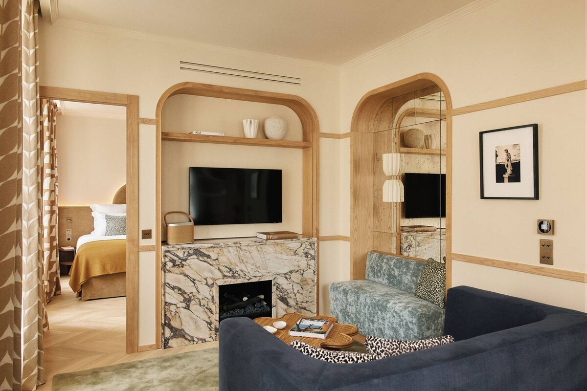 A modern living room with a TV, seating area, and a fireplace.