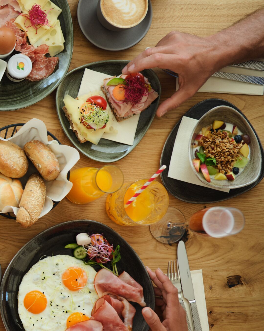 A breakfast setting with various dishes, including eggs, bread, and a coffee cup.