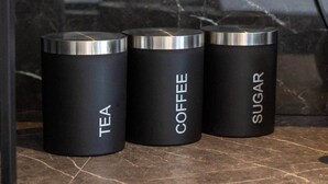 Three black containers with labels for tea, coffee, and sugar. - Cozy Garden Studio in St Albans (St Albans)