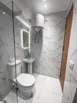 Shower, hair dryer, slippers, towels