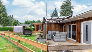 A wooden deck with outdoor furniture, a barbecue grill, and a pergola. - Holiday Home 'Ferienhaus 34' with Private Terrace, Shared Garden and Wi-Fi (Zadelsdorf)