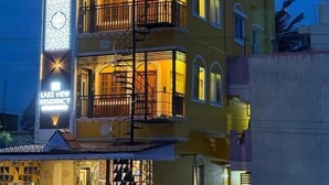 A multi-story building with balconies and a sign indicating it is a residence. - Lake View Residency (Puducherry)